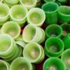 A pile of green cups sitting on top of a table