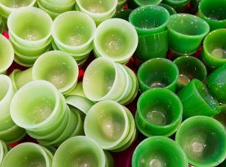 A pile of green cups sitting on top of a table